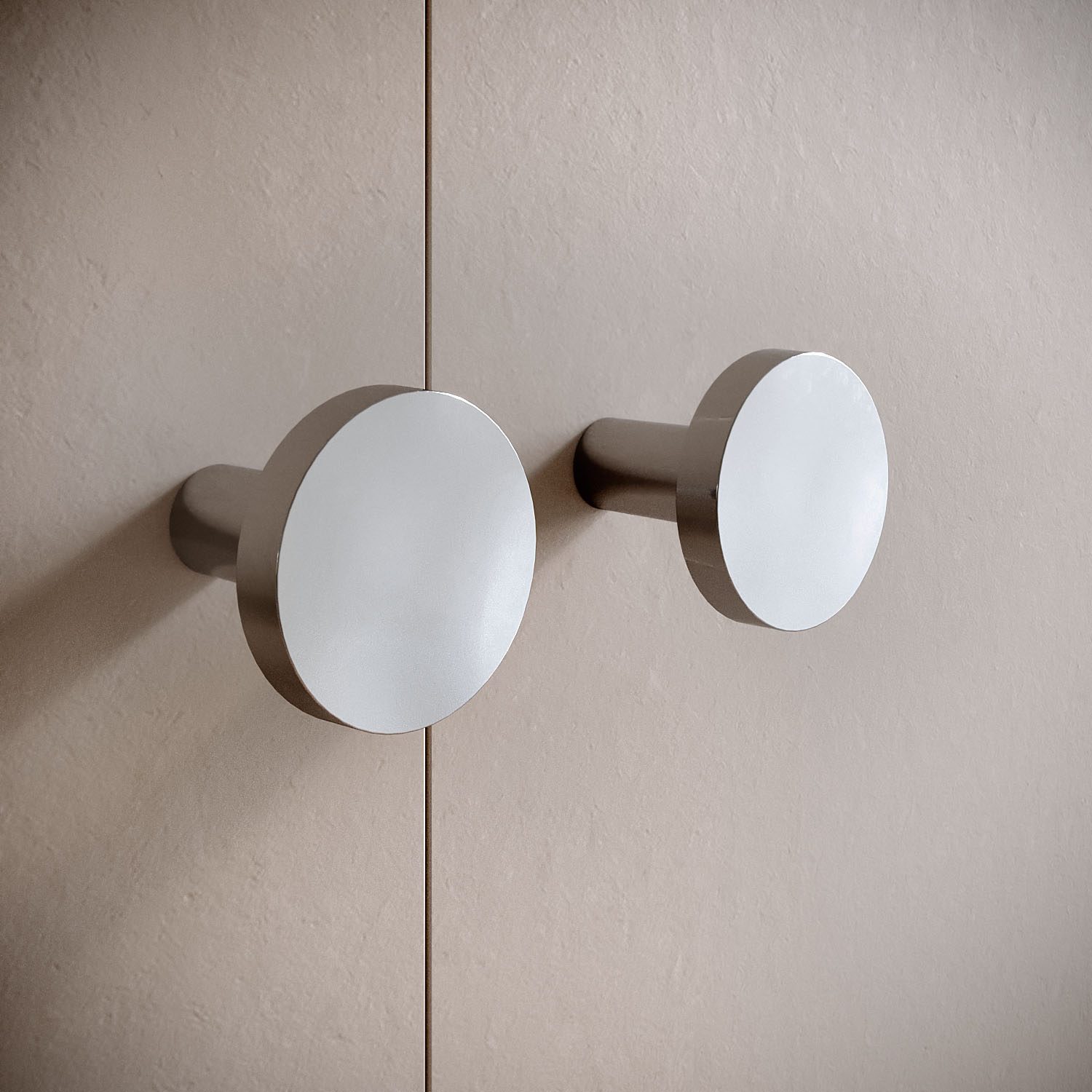 Zamak knobs with metallic finish on modern furniture panel